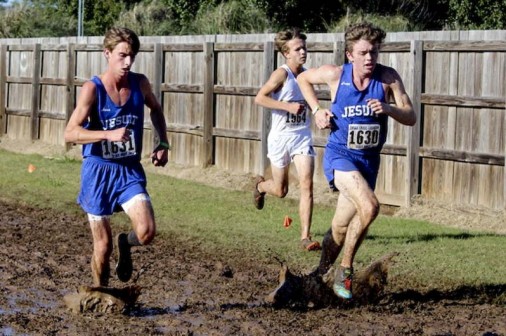 Junior Eli Sisung and senior John Nimmo battle the sloppy course at the state cross country meet..