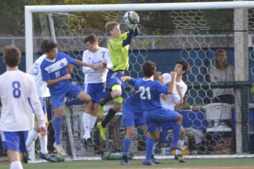 Sophomore goalie Shane Lanson  got plenty of business against the Greyhounds. Here, he soars above the crowd to thwart a corner kick.