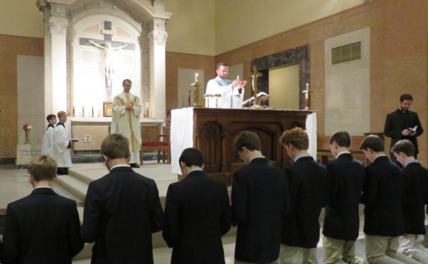 Candidates to the Sodality make their commitments kneeling before the Blessed Sacrament.