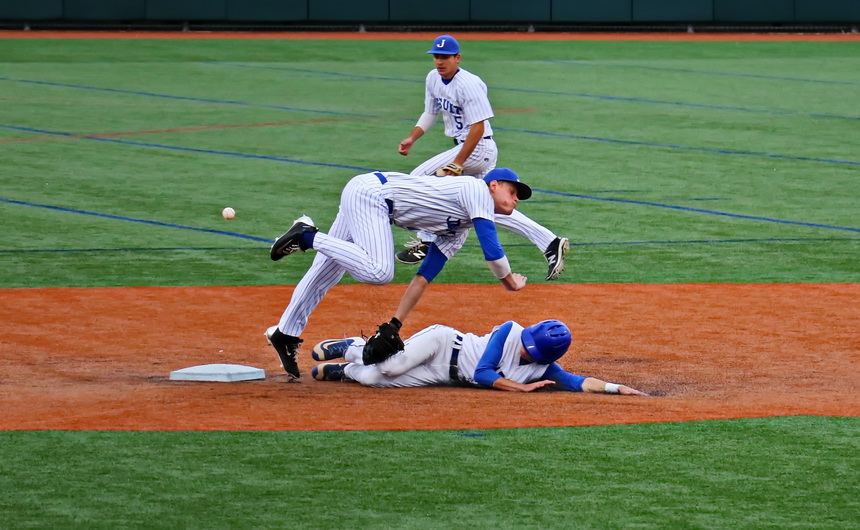 Shortstop Nick Ray goes up and over trying to tag a Tarpon runner stealing second base. The ball gets away from Ray but second baseman Brandon Briuglio is right there to back him up.
