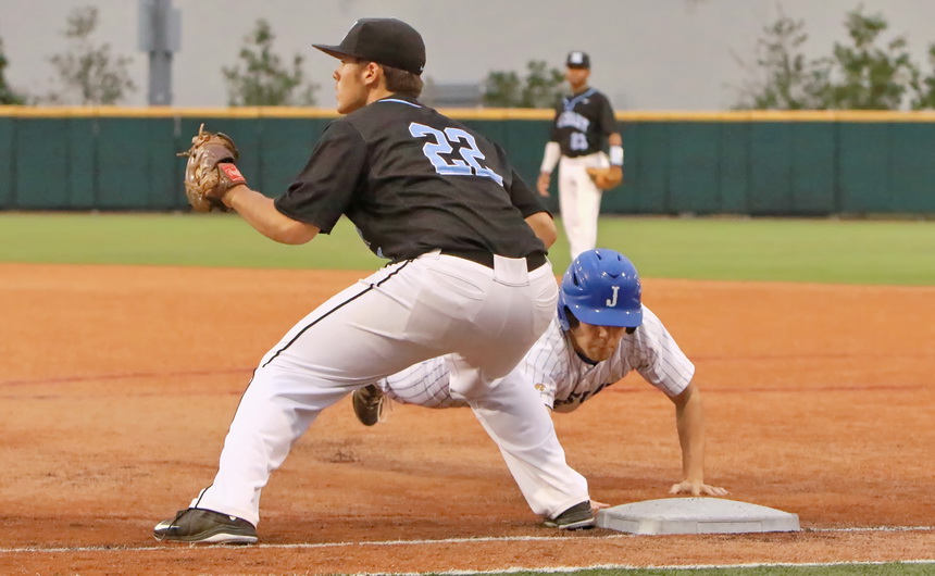 Courtesy runner Jake Chanove dives back to first base to avoid a tag.