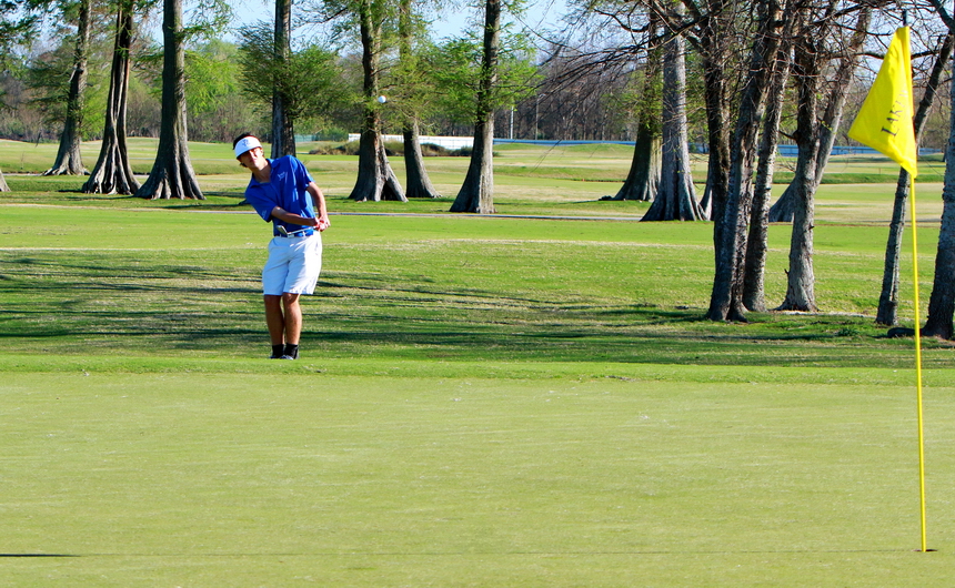 Grant Glorioso chips onto the par-3 number eight green. Glorioso shot a 36 to lead the Jesuit golf team to an eight-stroke win over Newman on Monday at Lakewood Golf Club.