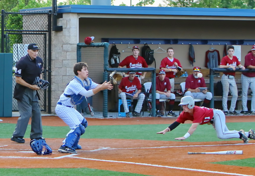 Jesuit catcher Josh Schmidt has the ball in sight and will make the tag on this Lion trying to slide safely home.