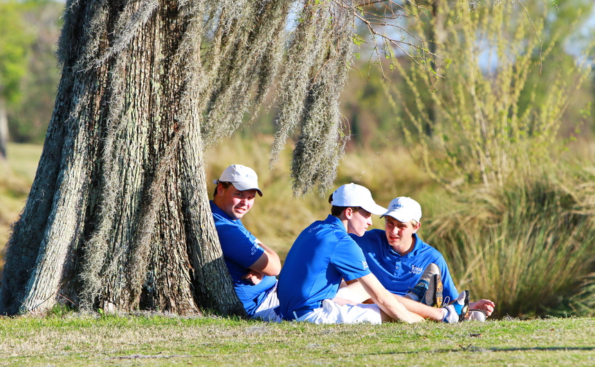 Blue Jay golfers, from left, senior Jonathan Cedro and sophomores Andrew Kuebel and Jack Vollenweider rest under a large cypress tree that dot the fairways of Lakewood Golf Club, Jesuit's home course.