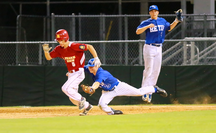 Second baseman Marc Theberge lunges to tag this Peake BMW runner who was caught between first and second bases in Monday night's game at Kirsch-Rooney Stadium. First baseman Grant Saunders leaps as Theberge makes the play, one which saved a run while also ending the inning.