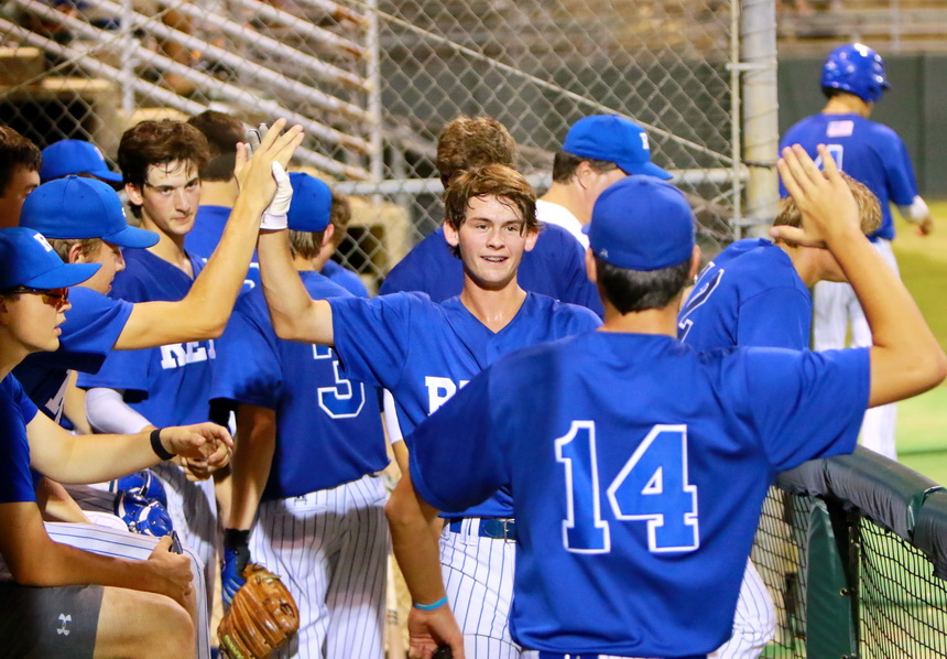 Mack Miller is congratulated by his teammates for breaking open the game against Peake BMW with a two-run double in the sixth inning.