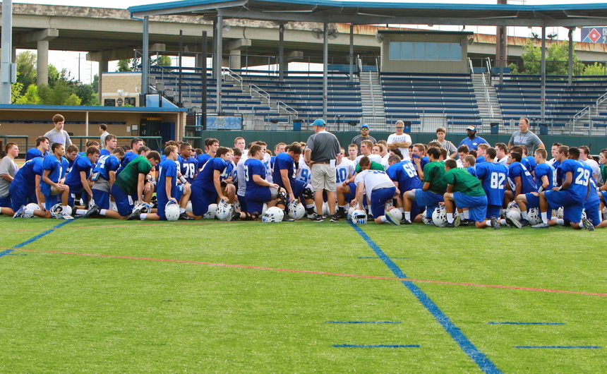 Coach Songy talks to the team following practice on Wednesday, April 18, at John Ryan Stadium.