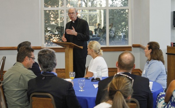 Fr. McGinn, S.J., welcomes new parents to campus to hear about ways to get involved in their sons' new school.