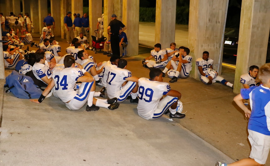 The Jays sit quietly on the walkway under the grandstand at Tad Gormley Stadium waiting out a 45-minute lightning delay with just under three minutes to play in their game against Warren Easton on Thursday, September 1.