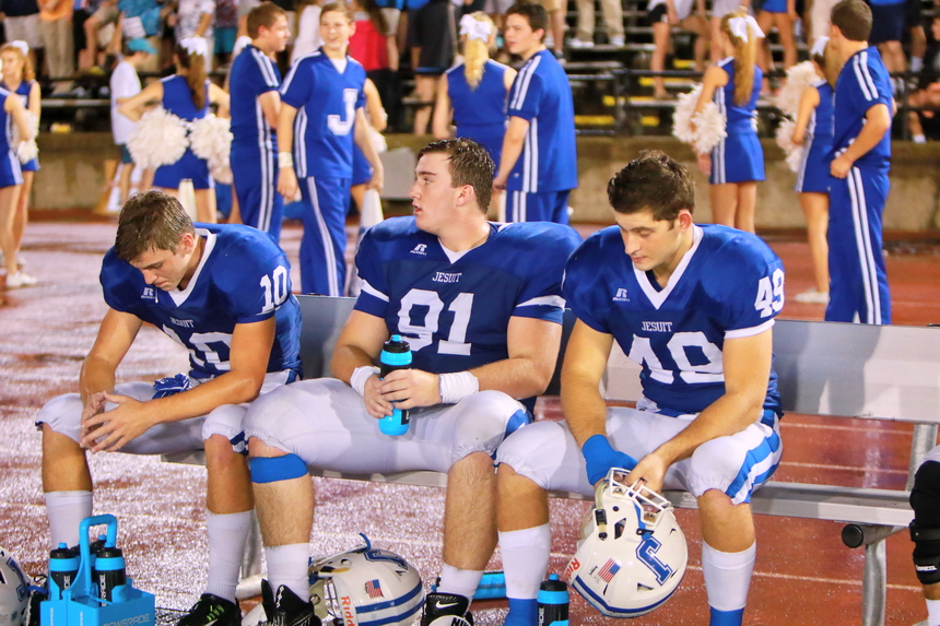 The defense rests: Evan Loria (10), Owen Melville (91), and Chase Adamcewicz (49) take a respite during last weekend's 34-13 win over Escambia.
