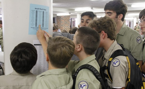 Students check the list of clubs and organizations to see which displays they want to visit.