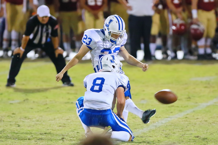 Denny McGinnis holds for Jake Chanove, who kicks a 40-yard field goal with four seconds left in the first half to put Jesuit on the scoreboard and cut Brother Martin's lead to 7-3.
