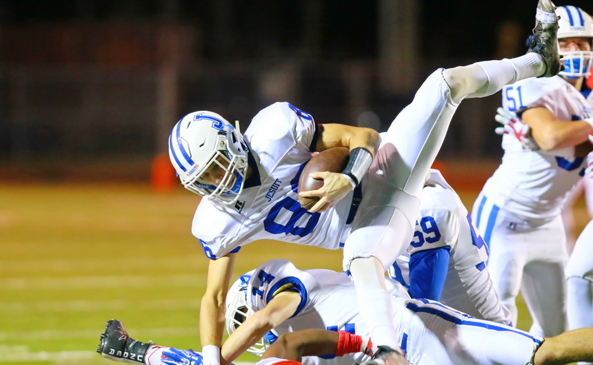 Bryce Musso is flipped over while returning a Raider kickoff in the second quarter.
