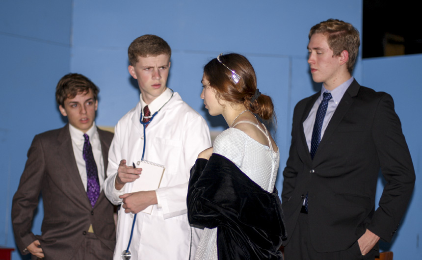 Dr. Emmett, played by Andrew Busenlener (second from left), consults the family of Mrs. Savage, played by (from left) Brice Catalano, Matt O'Neill, and Rachel Michelle.