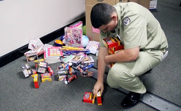 Cadet Sergeant Major Travis Kieff gathers toys to deliver to local children in need.