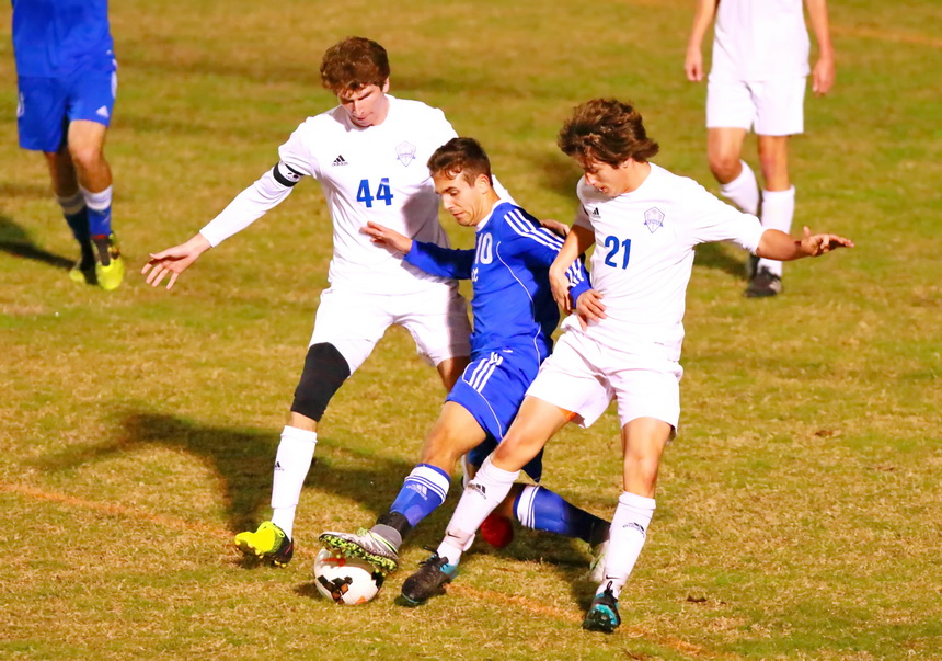 Senior midfielder Hunt Navar fights a pair of Skippers for control of the ball.
