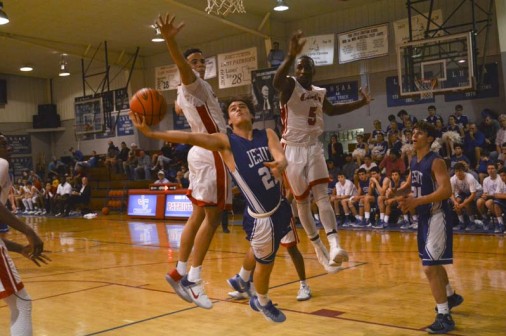 Sophomore Nick Artigues finds the lane to be tough sledding against the much taller John Curtis Patriots on Tuesday, Jan. 10.