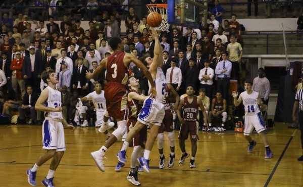 Nick Artigues finishes strong underneath the basket to keep Jesuit's offense moving.