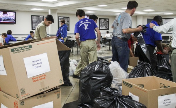 Before making their donation drop off, the group sorts through boxes and bags all of the winter-weather items they gathered over the two-week drive.
