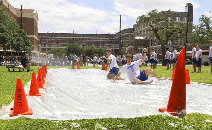 Seniors Noah Baquet and Max Bell perfect their form as they reach the landing zone of the slip-and-slide.
