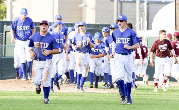 Following the 5-3 victory on Friday, Oilers run back to the dugout after shaking hands.