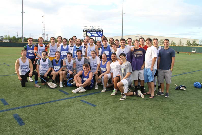 Lacrosse players shake hands and smile for a photo after the Blue and White game at the 2017 Lacrosse Homecoming.