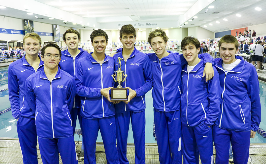 Senior swimmers receive their first place district trophy.