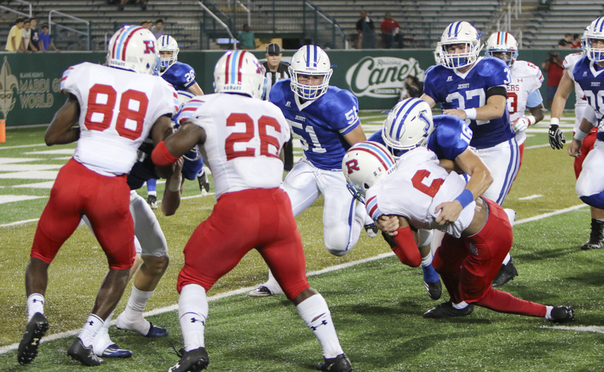 Junior defensive back Cameron Helm makes a perfect goal-line tackle to prevent the score on Rummel's 4th and 1.