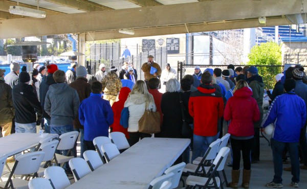 Mat Grau '68, alumni director, thanked the crowd for coming out despite the cold weather.