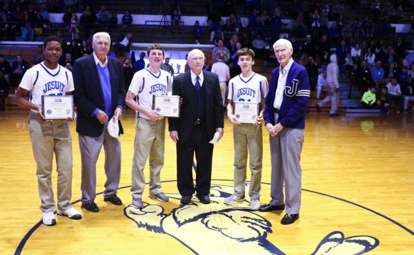 Three pre-freshman hoopsters were each given the honor of escorting a 1948 honoree to center court and presenting the honoree with his 70-year plaque. (From left) Jordan Johnson and Jules Mugnier '48, 
