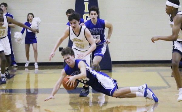 Junior Zach DeBlieux dives on the floor after a loose ball.