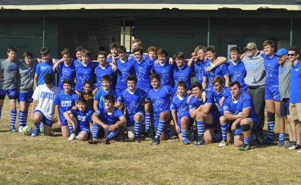The defending champion Jesuit ruggers celebrate their first victory of the season.