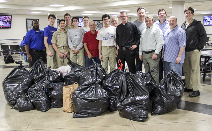 Last year's group poses with the donations before some of them head to the Harry Tompson Center (HTC). Pictured here (from left to right) are Earl Johnson '13, _____, _____, ______, freshman Connor Quaglino, ______, Pete Serio '67, senior Jack Quaglino, Glenn Schyed '67, Fr. Kevin Dyer, S.J., Ward Rice '84, Bryon Hatrel '84, Joe McMahon '84, Barry Sevin '84, and freshman Max McMahon.