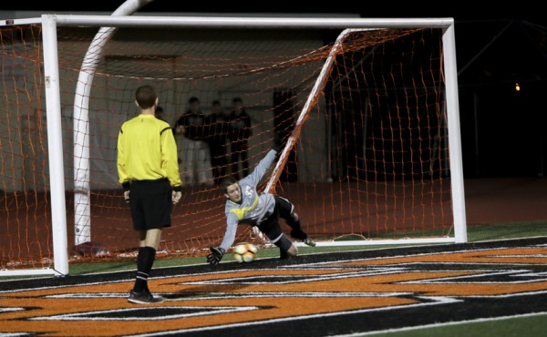 Lanson makes a fingertip save, the first of his five PK saves.