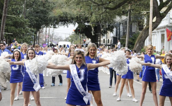 The 2018 cheerleading team marching and performing in the Krewe of Carrollton parade