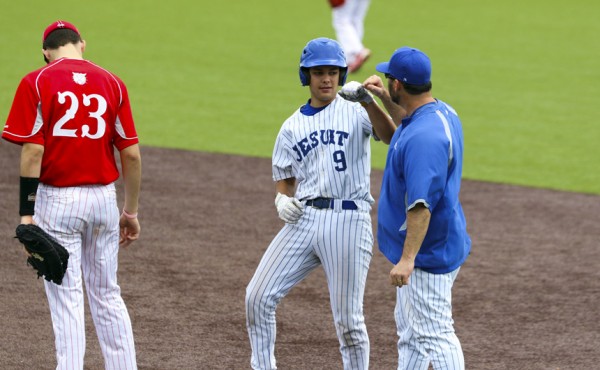 Connor Bendeck gets a congratulatory fist bump from Coach Kenny Goodlett after one of his two hits on Saturday morning. Bendeck drove in one run in the victory.