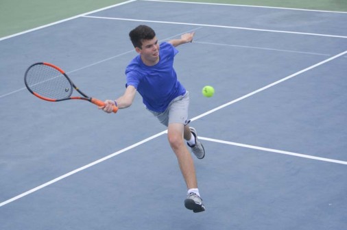 Sophomore James Henican reaches for a volley at the McGill-Toolen Tournament on Feb. 23.