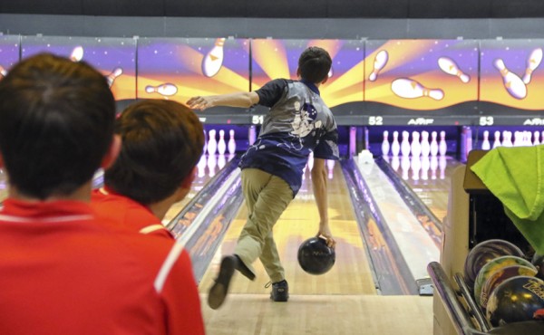 The competition watch as junior Jake Stiegler bowls his way to a strike.