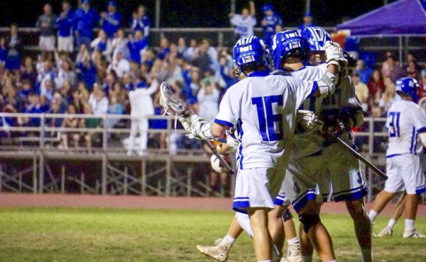 Sophomore Clark Romig celebrates after a Jesuit goal in the district final game. The sophomore was a crucial contributor in the game as he 
