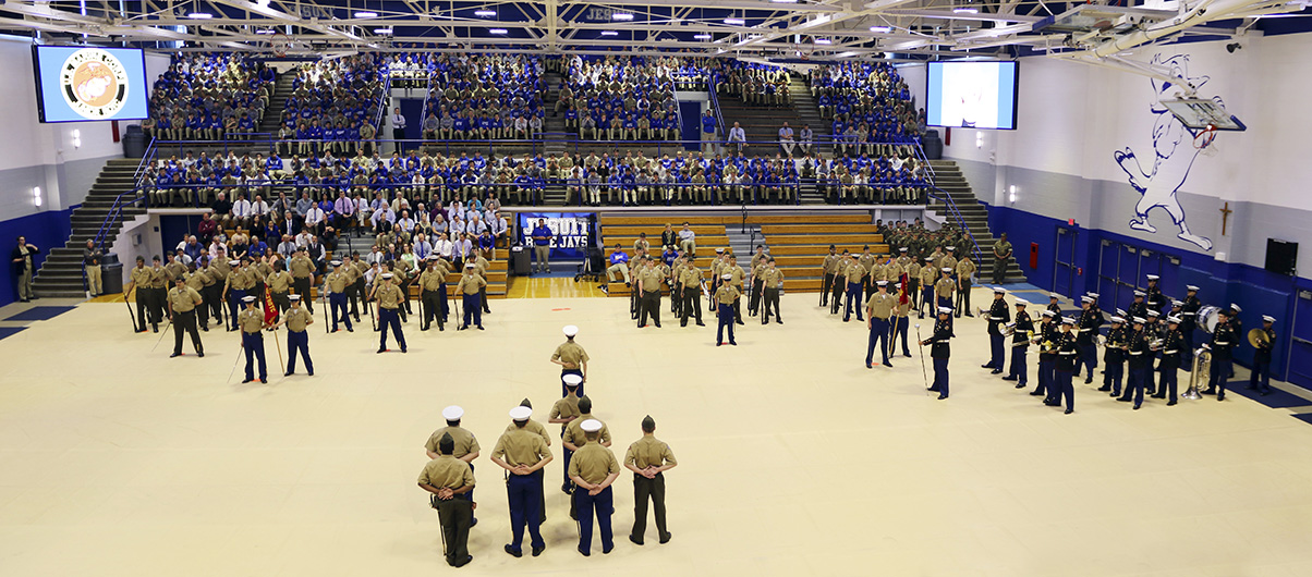 The entire student body watches the impressive presentation by the MCJROTC's various battalions and band.