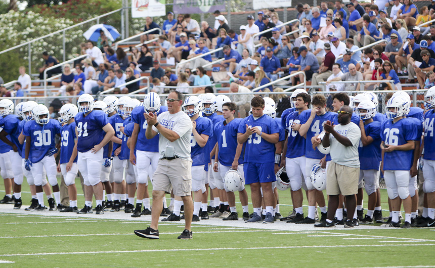 Coach Terry Ursin, sidelined Blue Jays, and the Jesuit crowd cheer after a touchdown!