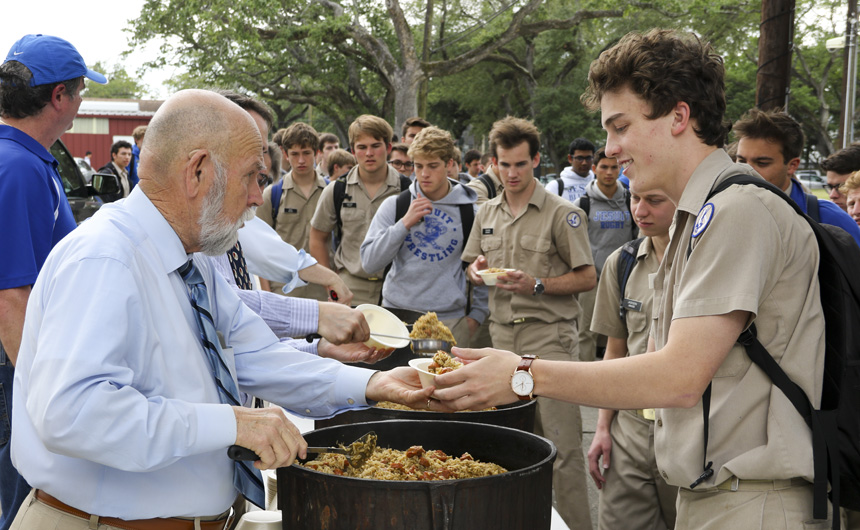 Senior Will Landrieu looks ready to chow down on the hot jamabalya Mr. "Top" Abshire is serving.